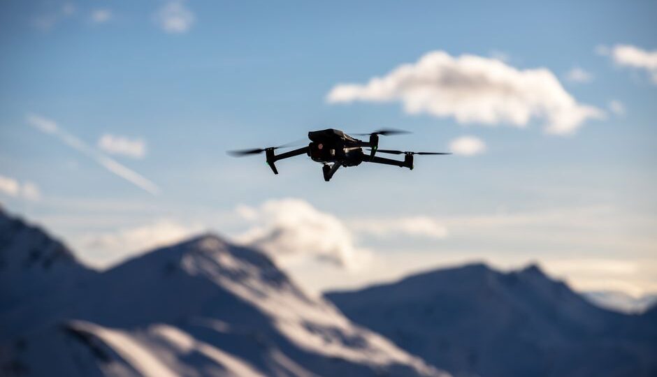 A drone equipped with LiDAR sensors surveying a landscape, showcasing advanced technology in surveying and data collection.