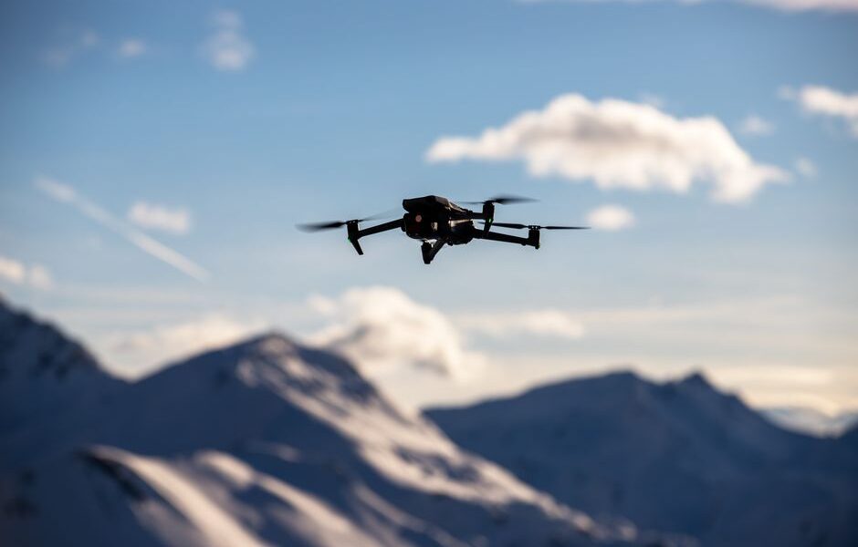 A drone equipped with LiDAR sensors surveying a landscape, showcasing advanced technology in surveying and data collection.